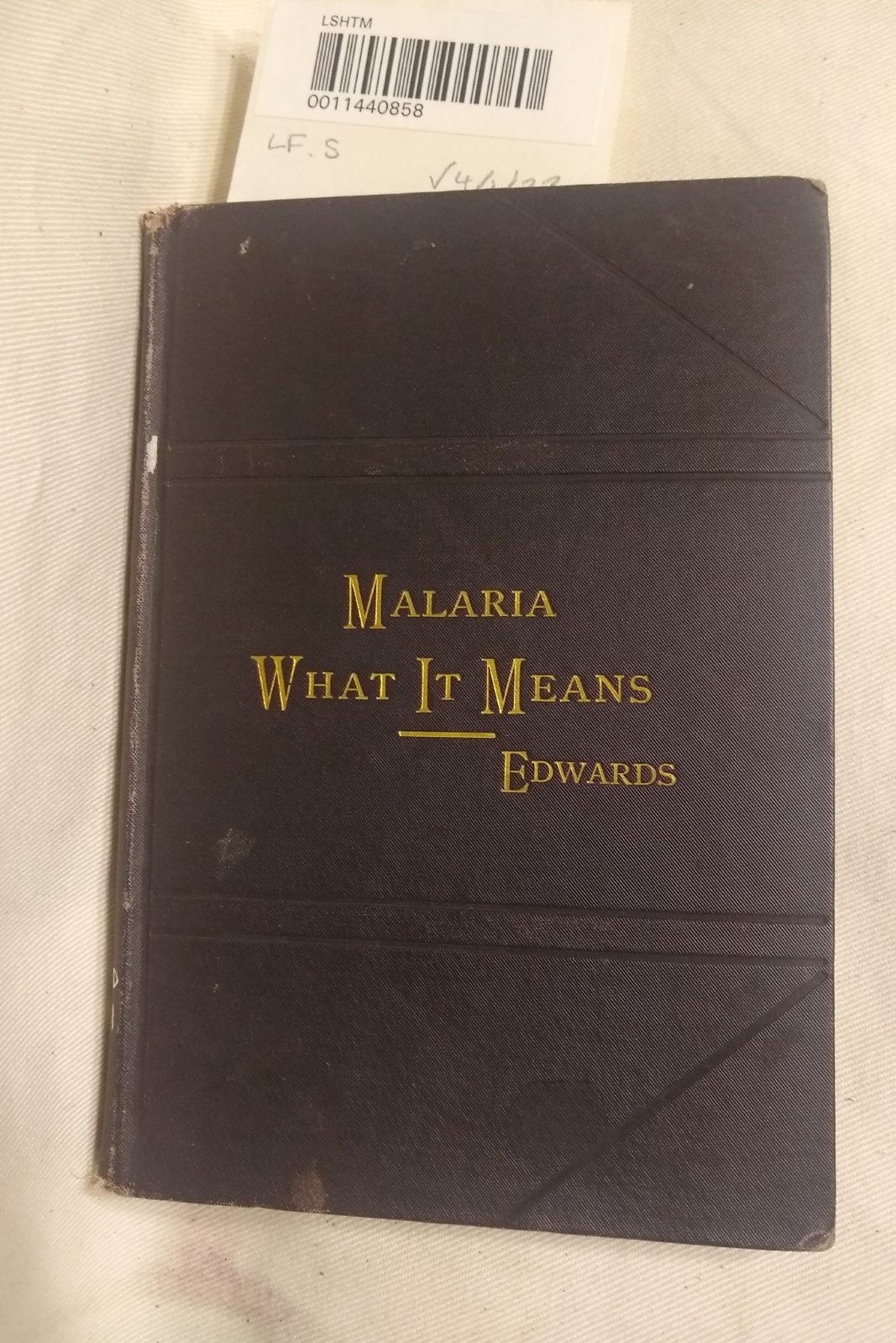 The cover of 'Malaria: what it means and how avoided,' in black with title and author surname in embossed gold letters.