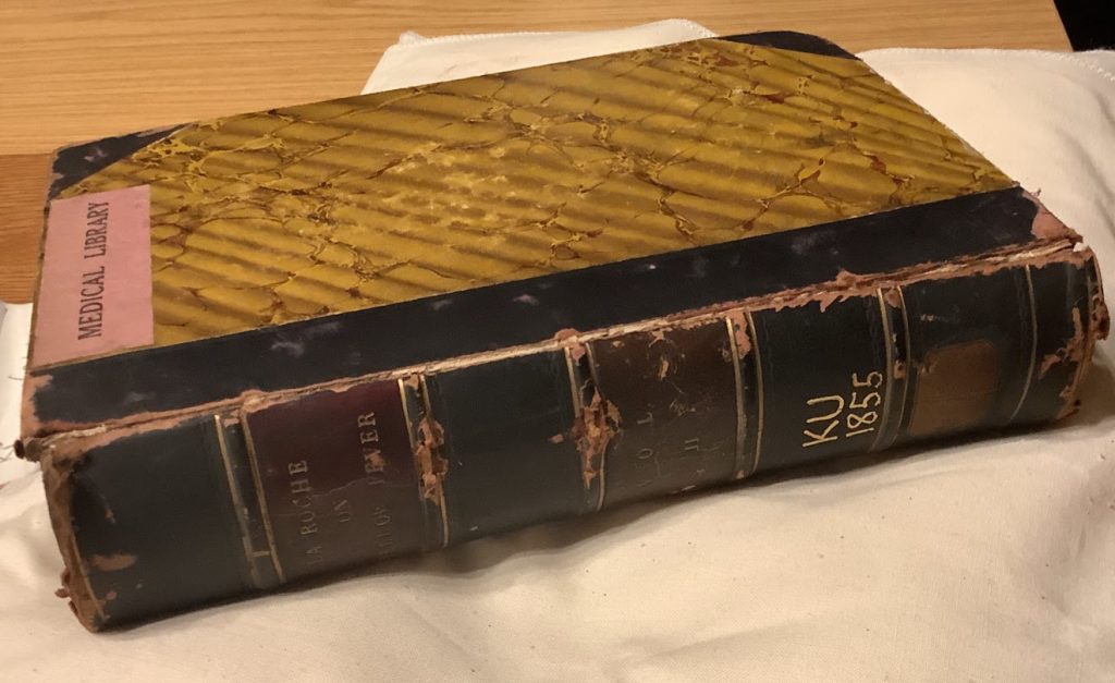 René La Roche's 'Yellow Fever,' bound in boards covered in yellow marbled paper and a red and black spine with embossed gold letters giving the title, author, and volume number (2).